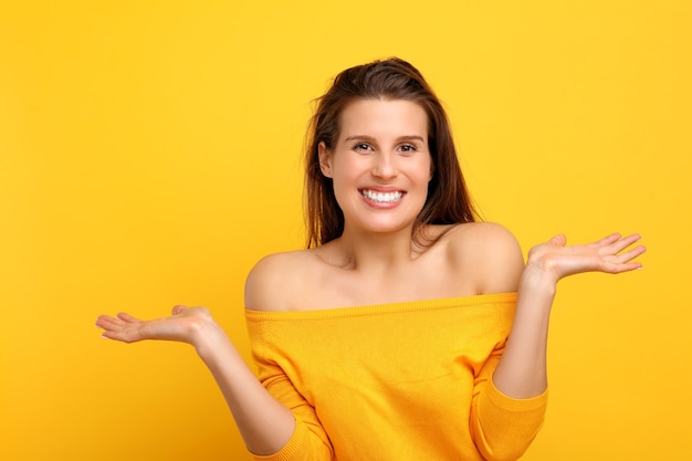 woman making faces against yellow