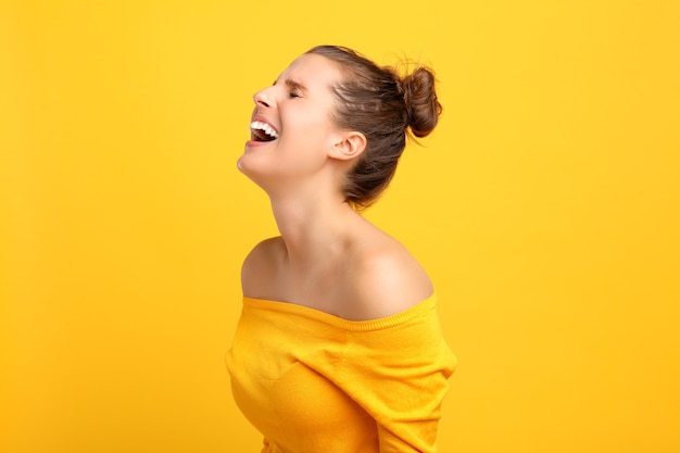 woman making faces against yellow