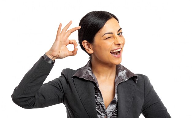 Woman making the ok sign isolated on white