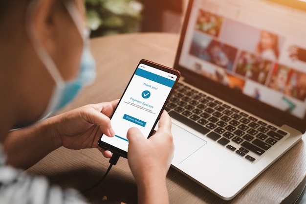 Woman making online payments on cell phone.