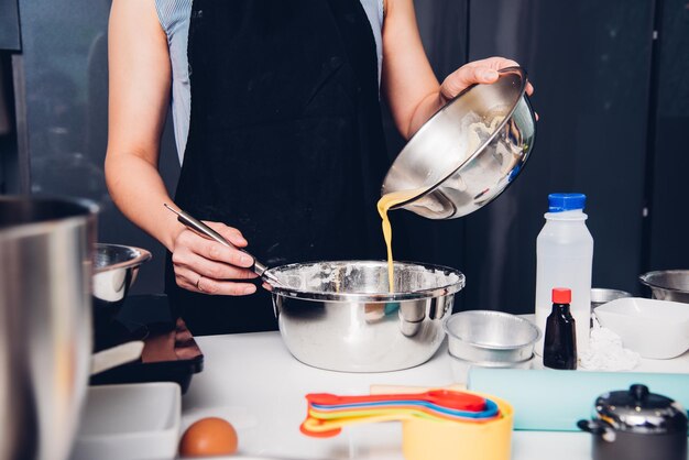 Woman during making pouring egg