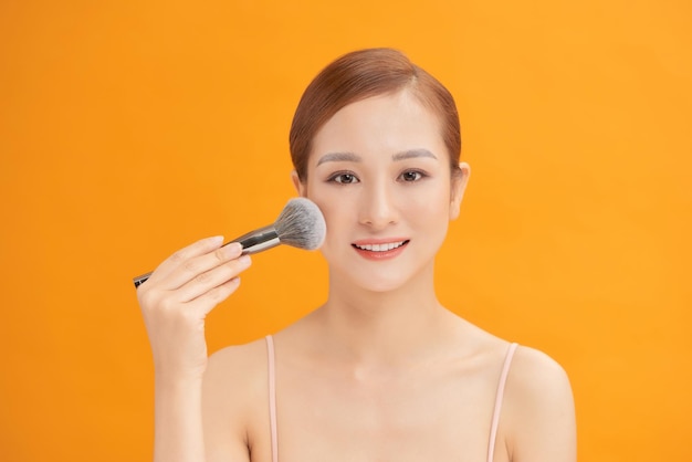 Woman making up makeup foundation brush