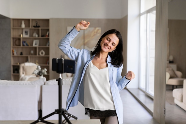 Photo woman making a vlog at home with her phone