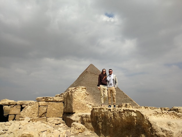 Woman and man against the background of the Giza pyramid