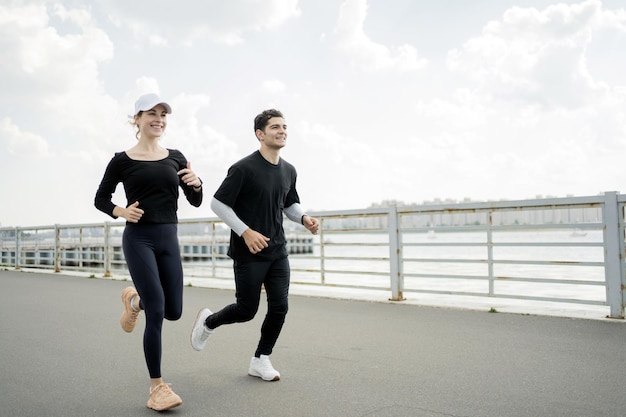 A woman and a man are running doing fitness on the street