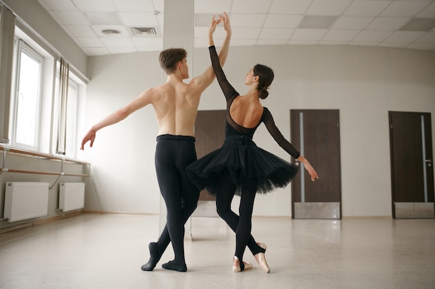 woman and man ballet dancers in action