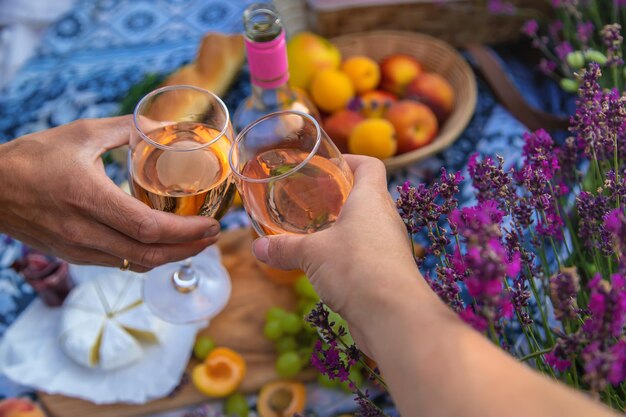 A woman and a man drink wine in a lavender field Selective focus