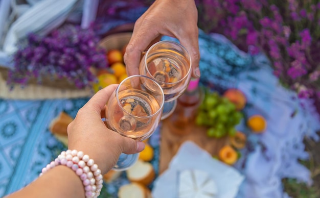 A woman and a man drink wine in a lavender field Selective focus