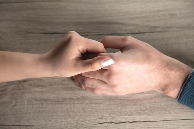 Woman and man hands on table