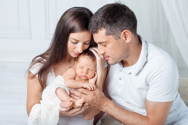 Woman and man holding a newborn