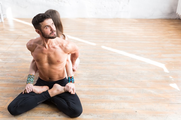 Woman and man relaxing in lotus position