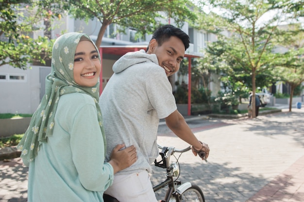 Woman and man riding a bike