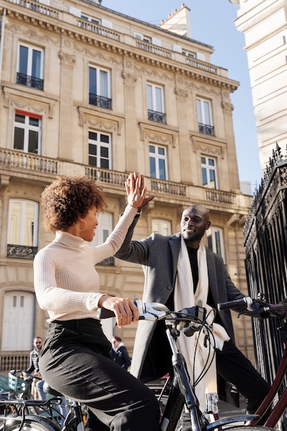 Photo woman and man riding bikes in the city in france