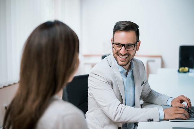 Woman and man talking during business meeting