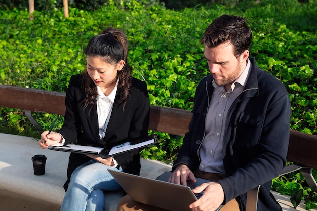 Woman and man working in a park next to the office