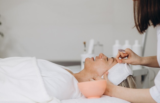 Woman in mask on face in spa beauty salon