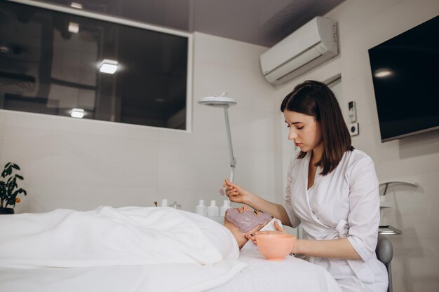 Woman in mask on face in spa beauty salon