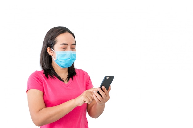 Woman in a mask using mobile phone