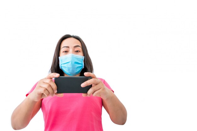 Woman in a mask using mobile phone