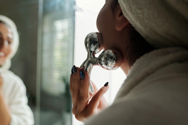 Woman Massaging Face with Roller