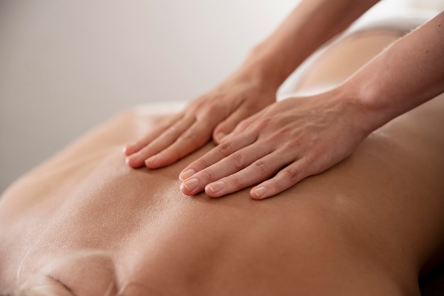 Woman massaging her client in her salon