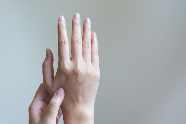 Woman massaging her painful hand.