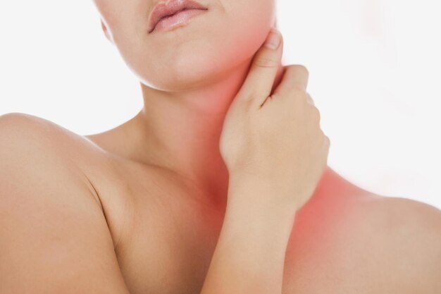 Photo woman massaging neck against white background