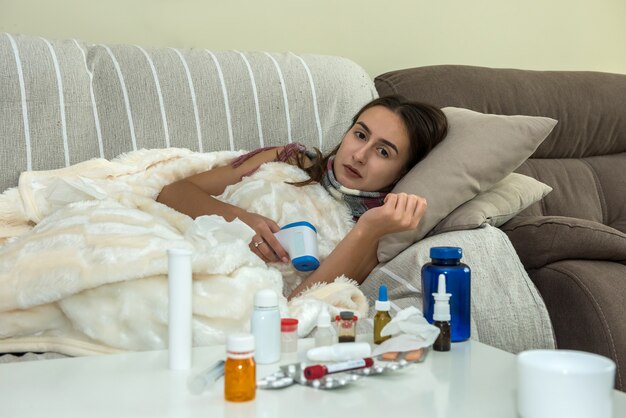 Woman measures temperatures infrared thermometer for diagnosing flu from Covid-19 infection. Coronavirus pandemic