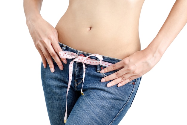 Woman measuring her waist- lose weight and healthy body concept- on white background.