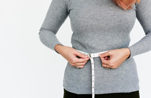 Woman measuring her waist