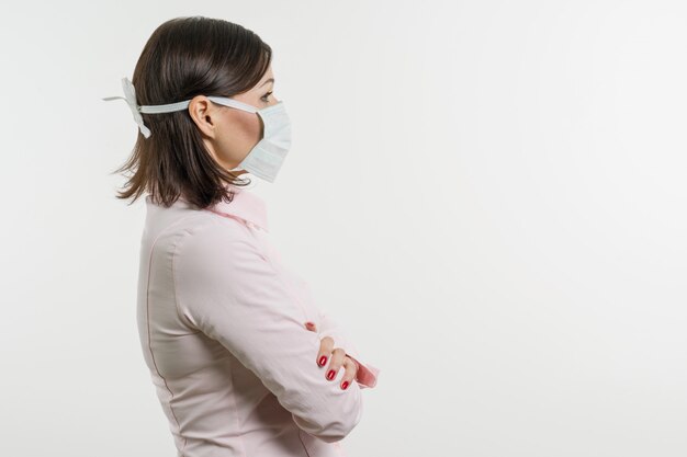 Woman in medical mask looking at profile