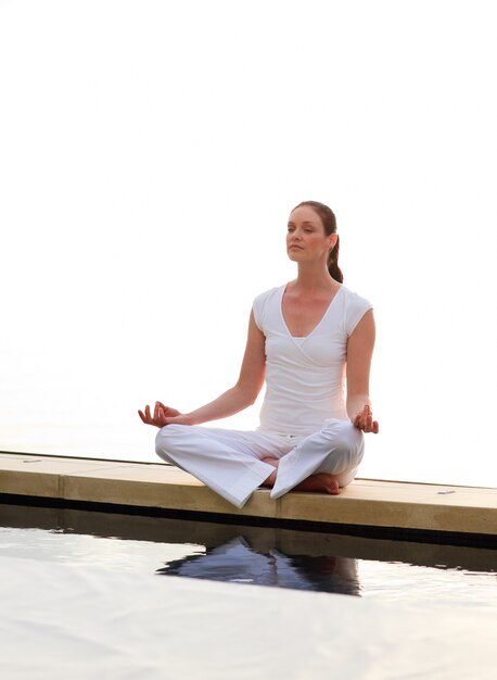 Woman meditating near the sea