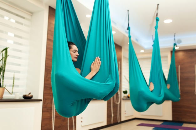 Woman meditation in hammock. 