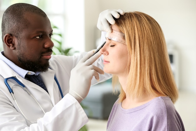 Woman meeting with plastic surgeon before operation in clinic