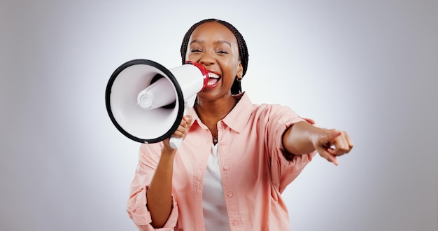 Photo woman megaphone and winner choice in announcement broadcast or join us for opportunity on a white background portrait of african person pointing you for competition bonus and winning in studio