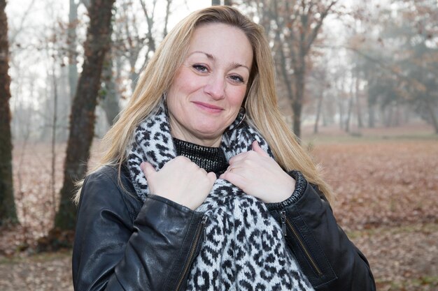 Woman middle aged outside winters or autumn with a scarf black and whiter