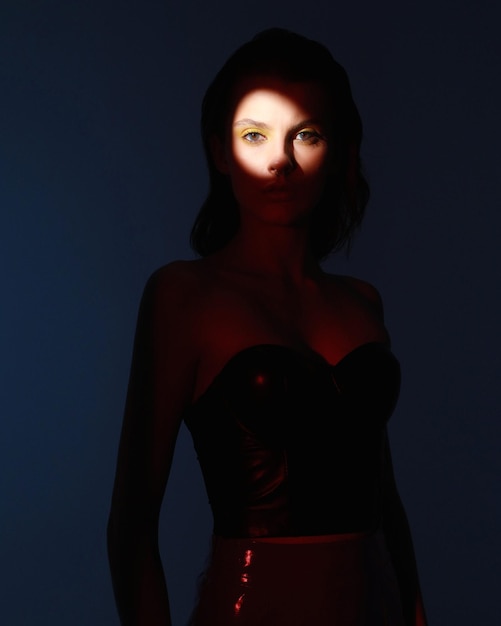 woman mixed artificial red and blue light and reflections Vogue trend Fashionable shoot Circle Gobo