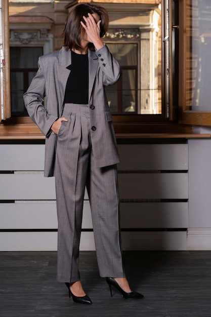 A woman model demonstrates a modern strict business suit A fashionable women's clothing store