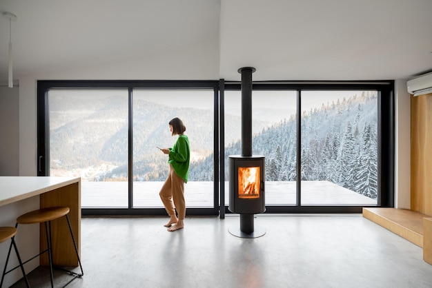 Woman at modern apartment with great view on the mountains