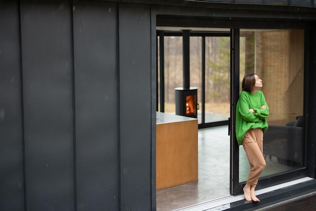 Woman at modern house on nature