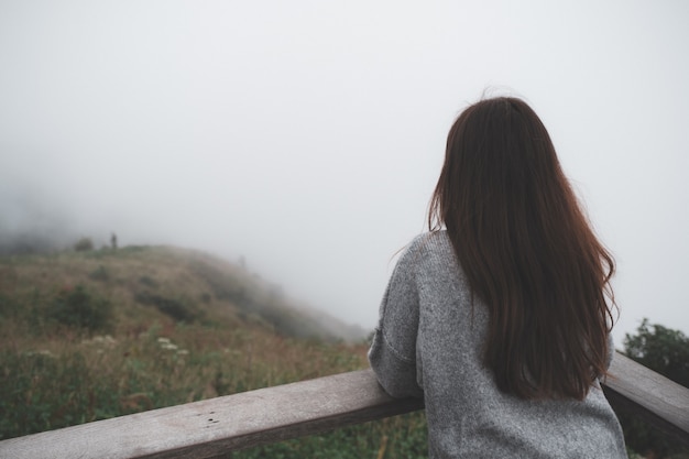 Woman on mountain with fog 