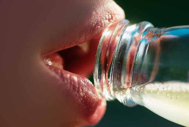 Woman mouth drinking water from bottle closeup drink water sensual lips