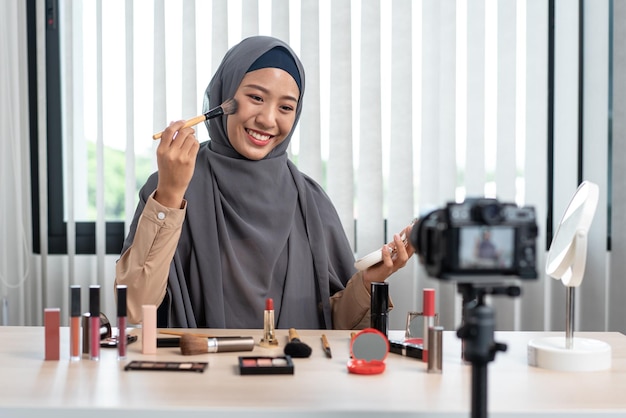 A woman Muslim blogger is showing present makeup tutorial beauty cosmetic review products