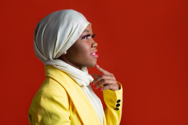 woman in muslim headscarf isolated on red