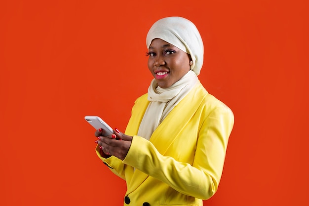 woman in muslim headscarf with mobile phone