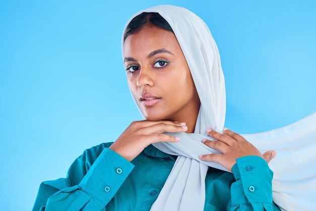 Woman muslim and portrait of hijab in studio blue background or color backdrop Young female model islamic culture or scarf for peace religion and arabic fashion of eid mubarak beauty or ramadan