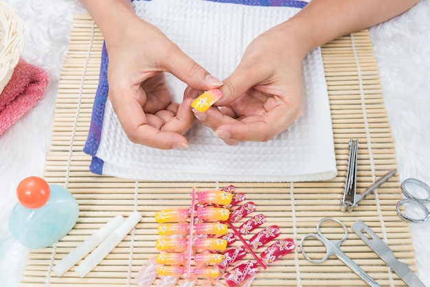 Woman in a nail salon and nail art receiving a manicure