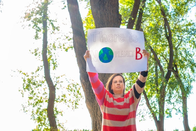 Woman in nature with climate change banner