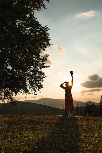 Woman near old big beech tree in the mountains