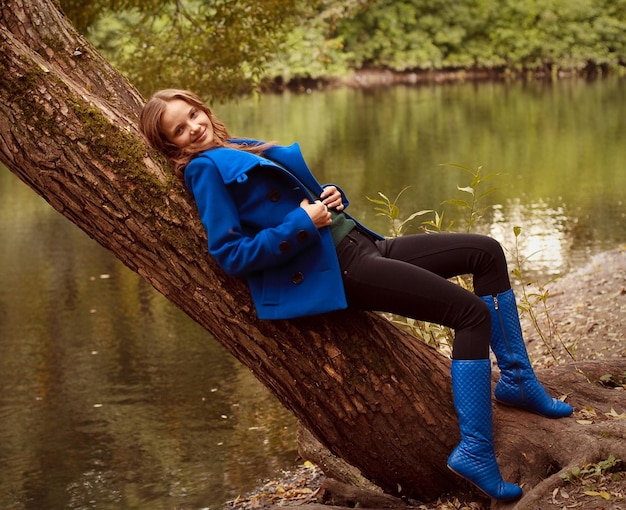 Woman near the river in autumn season